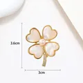 Detailed view of 3.6x3cm clover pearl brooch with shell petals and rhinestone stem - Gold Rimmed White MOP Clover Style (XX0034)