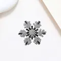Macro detail of rotating snowflake brooch with inlaid crystals and silver-tone finish - Xx0144