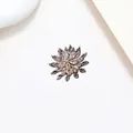 Macro detail of rotating snowflake brooch with sparkling crystals in rose gold finish - Xx0146