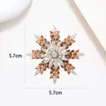 Detailed macro view showing the 5.7cm rotating snowflake brooch with colorful zircons - Xx0156