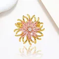 Detailed close-up of a floral brooch with pink marquise crystals and golden metal finish - Xx0197