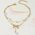 Detail of gold layered anklet featuring a small bow pendant and elegant white pearls - Bowknot Artificial Pearl Double Layer Style (TL0026)