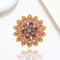 Macro detail of rotating snowflake brooch with pink and purple petals on gold plating - Xx0199