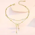 Detail of gold layered anklet featuring pearl accents and a butterfly bow tassel charm - Bowknot Tassel Artificial Pearl Style (TL0028)