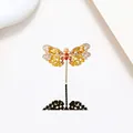 Macro shot of dragonfly brooch with yellow pavé crystals and pearl on white background - Yellow Orange Jewelry Pave Dragonfly Style (XX0126)
