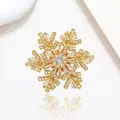 Macro detail of rotating snowflake brooch with gold plating and sparkling white crystals - Xx0206