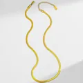 Detailed close-up of 18K gold plated stainless steel snake chain with lobster clasp and tag - Herringbone Chain / Gold