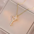 Elegant gold crown key pendant necklace with dancing zircon stone on a jewelry box - Gold Crown Key Necklace (X3588)