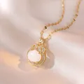 Elegant gold necklace with a white zircon-encrusted lock pendant on silk background - Vintage Scroll Oval Gem (X0231)
