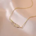 Elegant gold leaf pendant necklace with micro-pave crystals on champagne silk background - Gold-Golden Leaf (X0381)