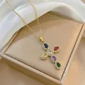 Detailed macro of a gold cross necklace featuring six colorful oval gemstones and zircons - Gold Tone Vintage Multicolor Cross (X3640)