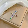 Detailed macro shot of a cross pendant with colorful zircon stones on a silk background - Silver Tone Multicolor Zirconia Cross (X1326)