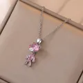 Cute pink crystal bear necklace in silver setting on champagne jewelry display - Pink Bear Necklace (X0842) / Pink