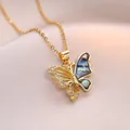 Elegant gold butterfly necklace with shimmering zircon stones and natural mother of pearl - Gold Butterfly Necklace