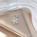 Detailed macro view of rotating flower pendant with sparkling zircon on beige jewelry stand - Silver Multi-color Floral Style (X0577) / Silver