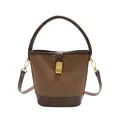Chic two-tone brown leather bucket bag with gold hardware and adjustable strap - Brown
