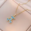 Chic golden bear necklace with blue zircon pendant on a beige jewelry display box - Blue (X1362)