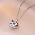 Macro shot of silver heart pendant with vibrant colorful inlaid gemstones on silk - Colorful Zirconia Heart Style (X1534)