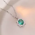 Elegant emerald green oval flower pendant necklace on beige silk background - Emerald Sunflower (X1411) / Steel Green