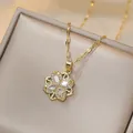 Close-up of golden clover pendant with marquise zircon on champagne satin box - Four-Leaf Flower Zirconia Necklace (X1864)