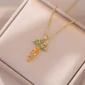 Colorful carrot zircon pendant necklace in gold setting on a beige jewelry box display - Gold Carrot Necklace Set