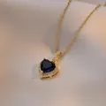 Elegant gold titanium heart necklace featuring a dark blue zircon pendant on satin silk - Blue Heart Style / Blue