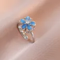 Bague fleur rotative élégante avec pierre œil-de-chat bleue et zircon en métal argenté S925 - Bague fleur bleue rotative argentée