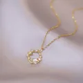Elegant celestial star necklace with moonstone pendant and zircon stones on satin background - Necklace & Pendant / Gold