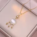 Close-up of dreamcatcher pendant necklace with white cat eye stone and hollow leaves - Dream Catcher Leaf Style (X2121) / Gold