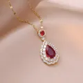 Elegant gold necklace featuring a teardrop ruby pendant with double halo zirconia stones - Red Teardrop Pendant (X2853) / Gold