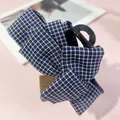 Blue and white plaid fabric bow hair clip on a minimalist wooden stand display - Hair Bow
