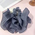 Navy blue and white checkered scrunchie with layered ruffle edge design on pink background - Ruffle Hem Scrunchie