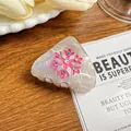 Pinza per capelli a triangolo iridescente con fiocco di neve rosa e strass lucidi - Rosso rosa