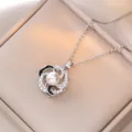 Rotating floral pendant necklace in silver with pearl center and black enamel accents - Silver