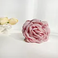 Pink fabric rose hair claw clip with multi-layer petals shown with elegant accessories - Dusty Rose