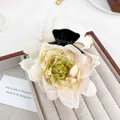 Elegant 3D rose hair claw clip in creamy white with pink edges on a velvet display - White Lotus