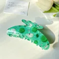 Translucent green claw clip featuring apple patterns and pink star sequins - 11cm Apple Green