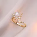 Anello a fiore dorato regolabile con perla centrale e zirconi su sfondo di seta rosa - J0304-oro