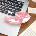 Pink marble dolphin hair claw clip made of acetate on a desk with a laptop - Pink Dolphin