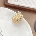 Mini gouden legering schedelhand haarklem met een glanzende metalen afwerking - Goud