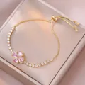 Bracciale dorato regolabile con ciondolo a quadrifoglio rosa e zirconi lucidi - Quadrifoglio a Cuore Rosa (TS0520) / Rosa