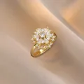 Golden snowflake spinning ring with sparkling white zircon stones on champagne silk - Hollow Snowflake Gemstone Style (J1194)
