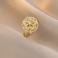 Rotating gold flower ring with sparkling white zircon micro-paving for women - Round Hollow Flower Style (J0314)