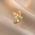 Elegant gold ring with four-color cat eye stones in a flower shape and zircon center - Clover Four-Color Gemstone Style (J0169)