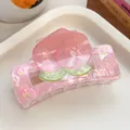 Close-up of pink peach hair claw clip with marble texture and peach print detail - Peach