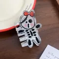 Detail of cartoon ghost hair claw clip with marble texture on a decorative table - Skeleton