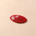Close-up of red fabric hair clip featuring white daisy embroidery and floral details - Red