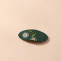 Detailed close-up of dark green oval BB clip with hand-embroidered white daisy flowers - Dark Green