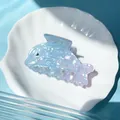 Detailed view of dolphin-shaped hair claw clip in gradient blue pearlescent acetate - Dolphin