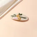 Close-up of floral embroidery on beige fabric BB hair clip with yellow daisies - Milk Coffee